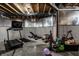 Unfinished basement area equipped with a treadmill and workout equipment at 3905 Pelham Rd, Carmel, IN 46074