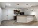 Finished basement bar with dark wood cabinets, wine rack, breakfast bar, and sleek pendant lighting at 3905 Pelham Rd, Carmel, IN 46074
