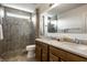 Bathroom with a tiled glass shower, double vanity and a neutral color palette at 3905 Pelham Rd, Carmel, IN 46074