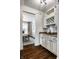 Butler's pantry with granite countertops and wine rack shelving, leading to the dining room at 3905 Pelham Rd, Carmel, IN 46074