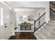 Elegant foyer with hardwood floors, staircase, and dining room view at 3905 Pelham Rd, Carmel, IN 46074
