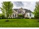 Charming brick home with a well-manicured lawn and lush landscaping at 3905 Pelham Rd, Carmel, IN 46074