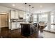 Open kitchen features white cabinets, stainless steel appliances, and a center island at 3905 Pelham Rd, Carmel, IN 46074