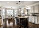 Kitchen with island, seating and stainless steel appliances and an adjacent dining space at 3905 Pelham Rd, Carmel, IN 46074