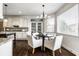 Eat-in kitchen features stainless appliances, white cabinets, an island, and natural light at 3905 Pelham Rd, Carmel, IN 46074