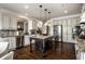 Kitchen with stainless steel appliances, white cabinets, island and granite counter tops at 3905 Pelham Rd, Carmel, IN 46074