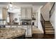 Open concept kitchen featuring decorative countertops, white cabinets, and stainless steel appliances at 3905 Pelham Rd, Carmel, IN 46074
