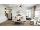 Open concept living room with view of kitchen, dining area, and staircase at 3905 Pelham Rd, Carmel, IN 46074