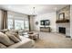 Inviting living room with fireplace, stone accent wall, and lots of natural light at 3905 Pelham Rd, Carmel, IN 46074