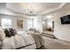 Spacious main bedroom features sitting area, natural light and a modern chandelier at 3905 Pelham Rd, Carmel, IN 46074