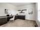 Home office featuring custom built-in desk and shelving with neutral carpet and modern decor at 3905 Pelham Rd, Carmel, IN 46074