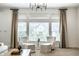 Sitting area with neutral color palette, large window, and seating for two at 3905 Pelham Rd, Carmel, IN 46074