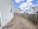 A grassless fenced backyard showing neighboring houses at 3941 Planewood Dr, Indianapolis, IN 46235