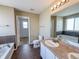 Spacious bathroom with double sinks, tile floors, and a separate tub and shower, offering modern comfort at 3941 Planewood Dr, Indianapolis, IN 46235