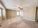 Bright bedroom featuring a ceiling fan and a door leading to another area in the home at 3941 Planewood Dr, Indianapolis, IN 46235