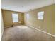 The bedroom provides three sunlit windows with a spacious, neutral-toned interior design at 3941 Planewood Dr, Indianapolis, IN 46235