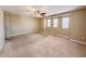 Bedroom with a ceiling fan, a doorway, and three windows offering ample natural light at 3941 Planewood Dr, Indianapolis, IN 46235