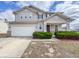 Charming two-story home featuring a covered entryway, attached garage, and well-maintained landscaping at 3941 Planewood Dr, Indianapolis, IN 46235