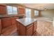 Open-concept kitchen with a convenient island, wood-look floors, and ample storage space at 3941 Planewood Dr, Indianapolis, IN 46235