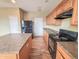 Well-equipped kitchen featuring wood-look floors, black appliances, and a functional center island at 3941 Planewood Dr, Indianapolis, IN 46235