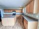 Large kitchen with ample cabinets, a functional island with barstool seating, and modern appliances at 3941 Planewood Dr, Indianapolis, IN 46235
