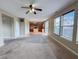 Open-concept living room showcasing the kitchen, windows and access to other rooms of the home at 3941 Planewood Dr, Indianapolis, IN 46235