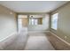 Bright, open-concept living area with neutral walls, carpet, and view into dining area at 3941 Planewood Dr, Indianapolis, IN 46235