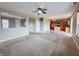 Open living room showcasing the kitchen, multiple windows, interior doors, and ceiling fan at 3941 Planewood Dr, Indianapolis, IN 46235