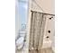 Stylish bathroom with a tub/shower combo, mosaic tile, black hardware, and wood-look tile floors at 4224 Cornelius Ave, Indianapolis, IN 46208
