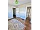 Bedroom featuring hardwood floors, white trim, a colorful rug, and an open closet at 4224 Cornelius Ave, Indianapolis, IN 46208