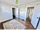 Bedroom with hardwood floors, white trim, a colorful rug, and two open doors at 4224 Cornelius Ave, Indianapolis, IN 46208
