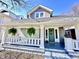 Charming home with a covered front porch featuring hanging ferns and a decorative green front door at 4224 Cornelius Ave, Indianapolis, IN 46208