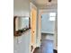 Hallway with a decorative mirror and shelf, leading to a room with hardwood floors and natural light at 4224 Cornelius Ave, Indianapolis, IN 46208