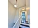 Bright hallway with a globe pendant light and white railing leading to an open doorway at 4224 Cornelius Ave, Indianapolis, IN 46208