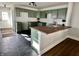 Modern kitchen with green cabinets, butcher block countertops and black hexagon tile flooring at 4224 Cornelius Ave, Indianapolis, IN 46208