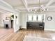 Open-concept living space with fireplace, hardwood floors, and built-in cabinet at 4224 Cornelius Ave, Indianapolis, IN 46208