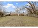 Expansive backyard featuring brick home, green grass, and tall privacy fence at 4457 N Kenmore Rd, Indianapolis, IN 46226