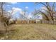 Sprawling backyard, showcasing a brick house, green grass and privacy fence at 4457 N Kenmore Rd, Indianapolis, IN 46226