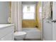A cozy bathroom featuring a bathtub with tile surround, a white vanity, and neutral decor at 4457 N Kenmore Rd, Indianapolis, IN 46226