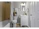 A well-lit bathroom features a tub/shower and sleek vanity, offering a serene and functional space at 4457 N Kenmore Rd, Indianapolis, IN 46226