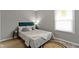 A well-lit bedroom featuring stylish decor, a comfortable bed, and hard wood flooring at 4457 N Kenmore Rd, Indianapolis, IN 46226