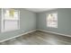 A bright bedroom featuring a window offering natural light and hard wood flooring at 4457 N Kenmore Rd, Indianapolis, IN 46226
