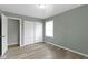 A neutral bedroom provides closet space, natural light, and hard wood flooring at 4457 N Kenmore Rd, Indianapolis, IN 46226
