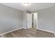 A bedroom featuring hard wood floors, neutral paint, and a closet, providing comfort and style at 4457 N Kenmore Rd, Indianapolis, IN 46226