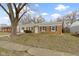 Cozy brick home with blue shutters, showcasing its simple yet appealing facade at 4457 N Kenmore Rd, Indianapolis, IN 46226