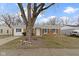Charming brick home with blue shutters and a well-maintained front lawn at 4457 N Kenmore Rd, Indianapolis, IN 46226