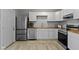 Bright kitchen with stainless steel appliances, modern white cabinets, and butcher block countertops at 4457 N Kenmore Rd, Indianapolis, IN 46226