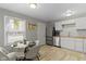 Charming kitchen featuring stainless steel appliances, white cabinets, and a cozy breakfast nook at 4457 N Kenmore Rd, Indianapolis, IN 46226