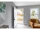 Bright living room with an open door, gray walls, and modern flooring at 4457 N Kenmore Rd, Indianapolis, IN 46226