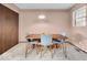 Cozy dining area with natural light, a modern pendant light fixture and sleek table and chairs at 504 Pelenor Dr, Franklin, IN 46131